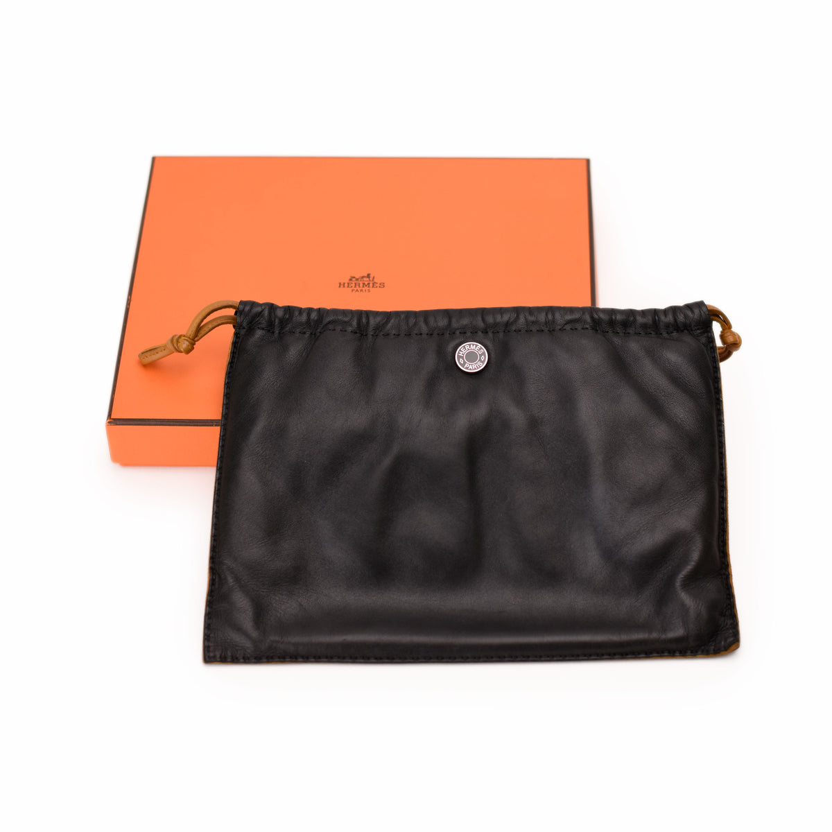 Hermès orange signature box and black leather dust bag. curated Pre-loved Luxury by Myluxe in Helsinki.