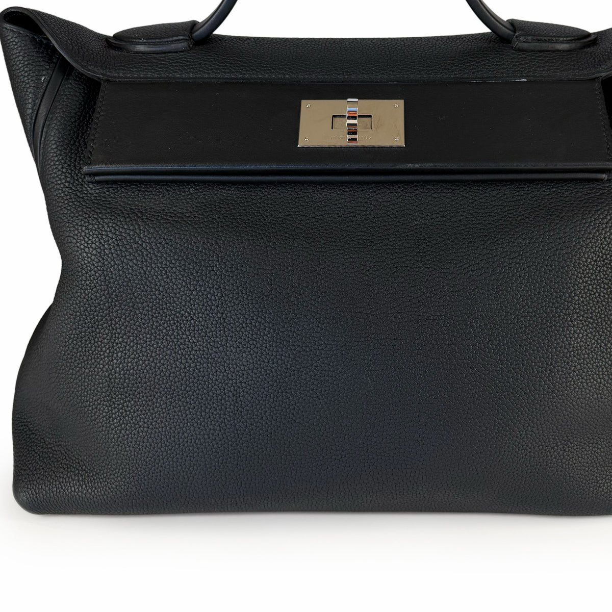 Black pebbled leather handbag with silver metal turnlock closure, curated Pre-loved Luxury by Myluxe in Helsinki.