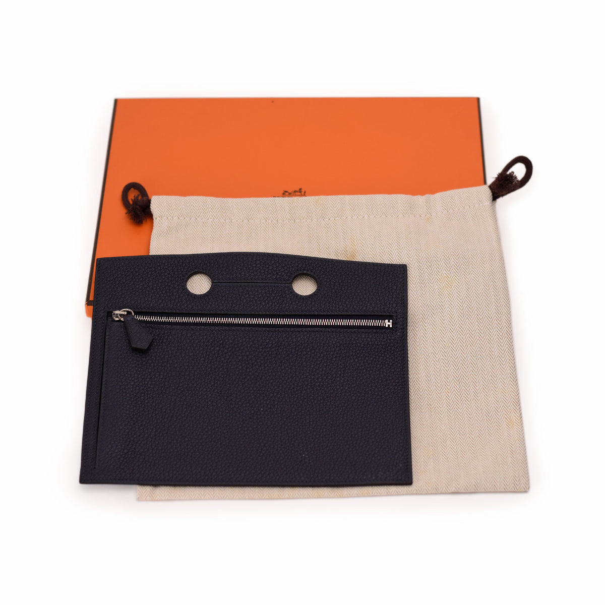 Black grained leather Hermès pouch with zipper, dust bag and orange box. curated Pre-loved Luxury by Myluxe in Helsinki.
