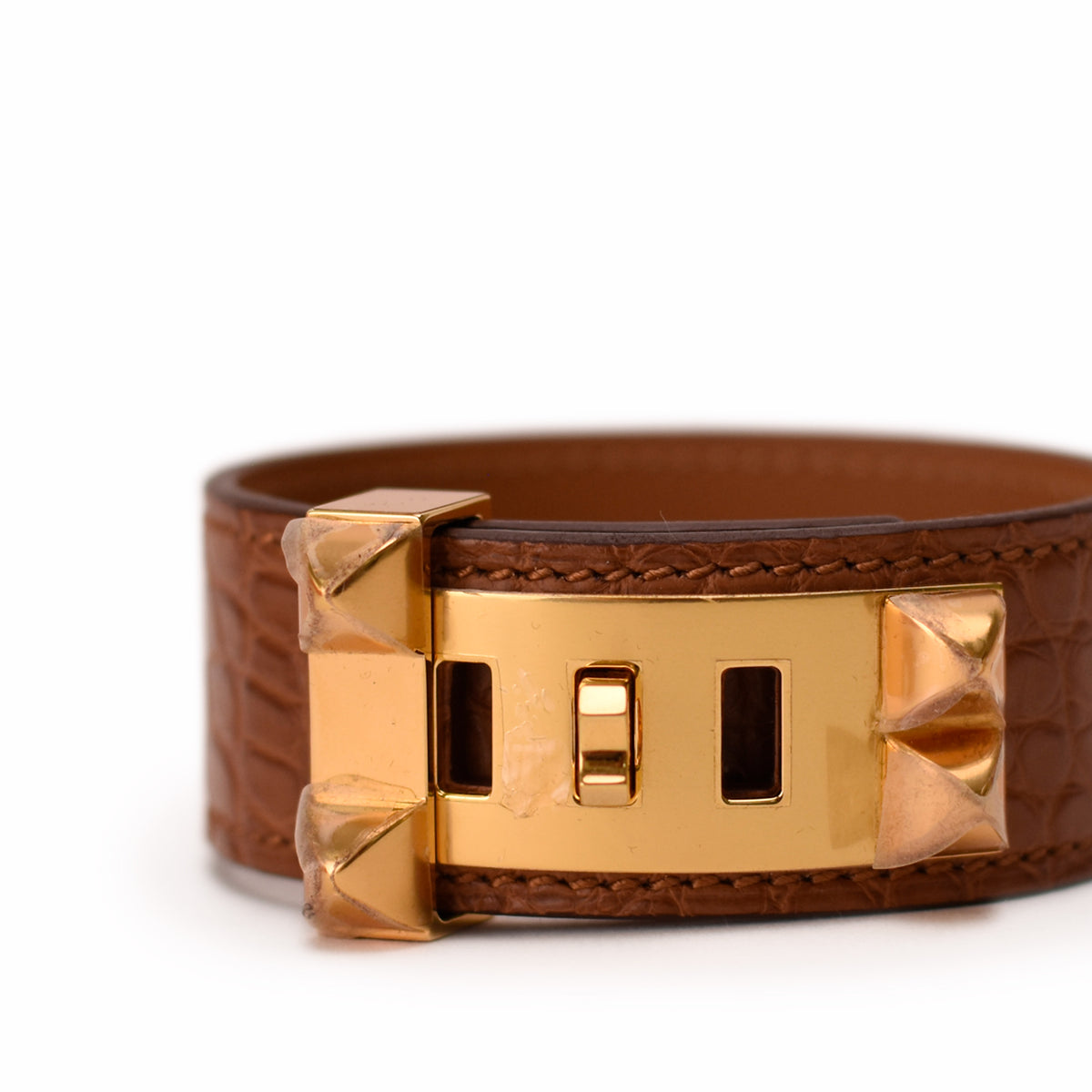 Brown crocodile leather bracelet with gold-tone metal hardware. curated Pre-loved Luxury by Myluxe in Helsinki.