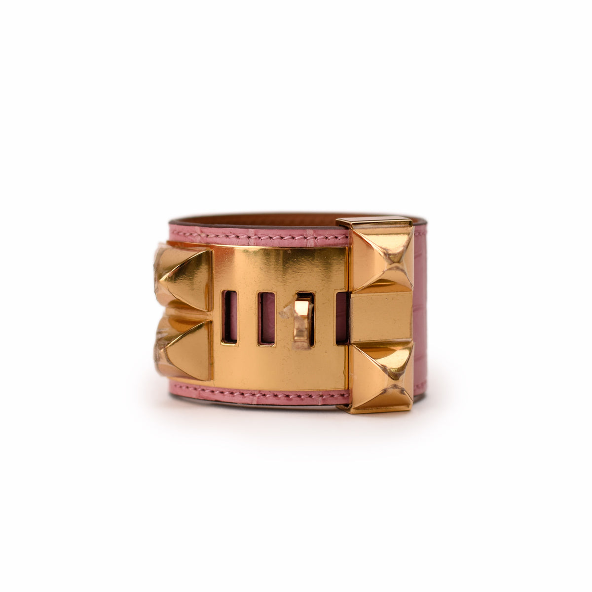 Pink crocodile-embossed leather cuff bracelet with gold-tone hardware. curated Pre-loved Luxury by Myluxe in Helsinki.