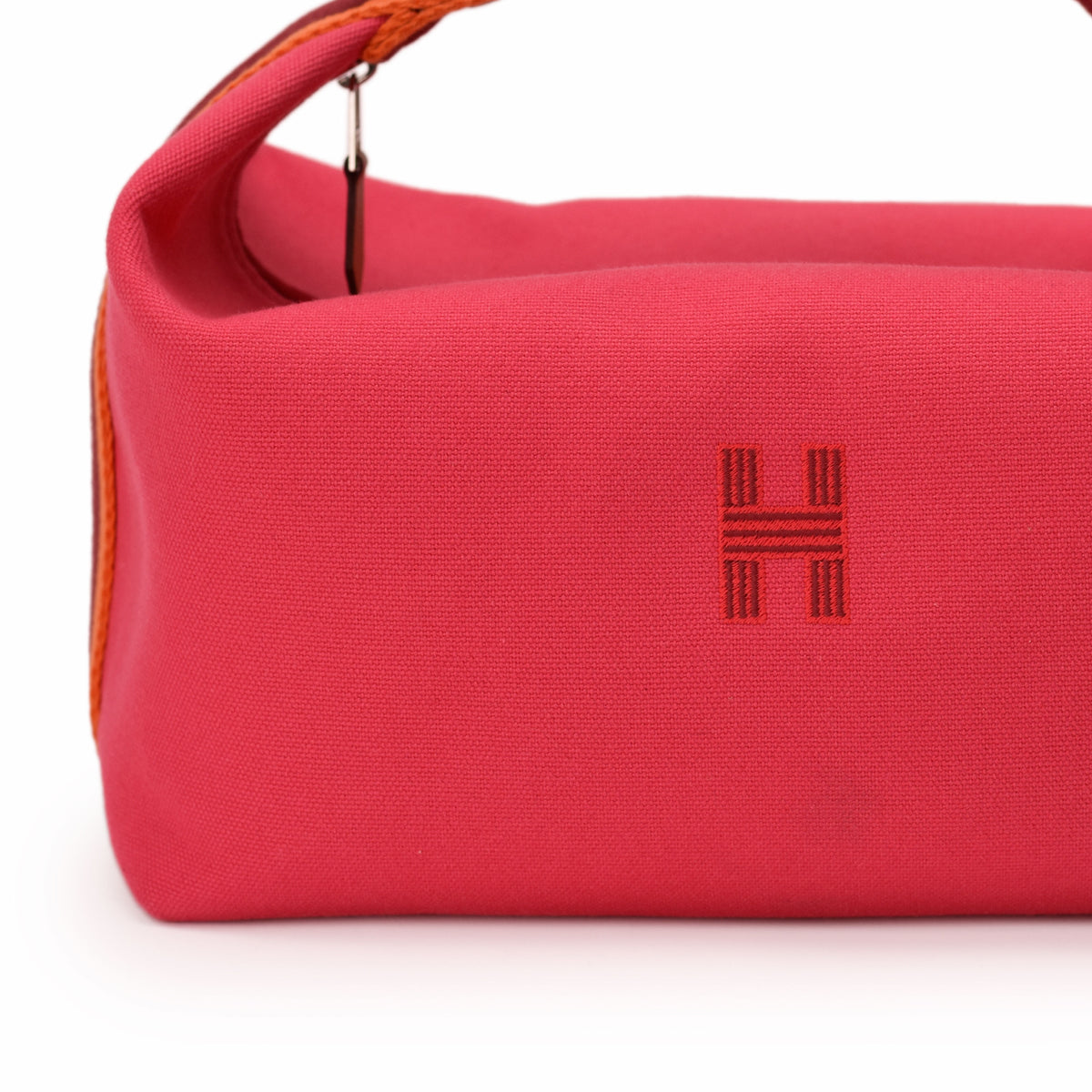 Close-up of a pink canvas Hermès bag featuring an embroidered H logo, curated Pre-loved Luxury by Myluxe in Helsinki.