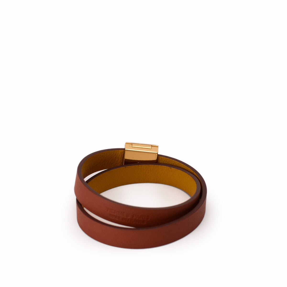 Tan leather wrap bracelet with gold-tone metal clasp. curated Pre-loved Luxury by Myluxe in Helsinki.