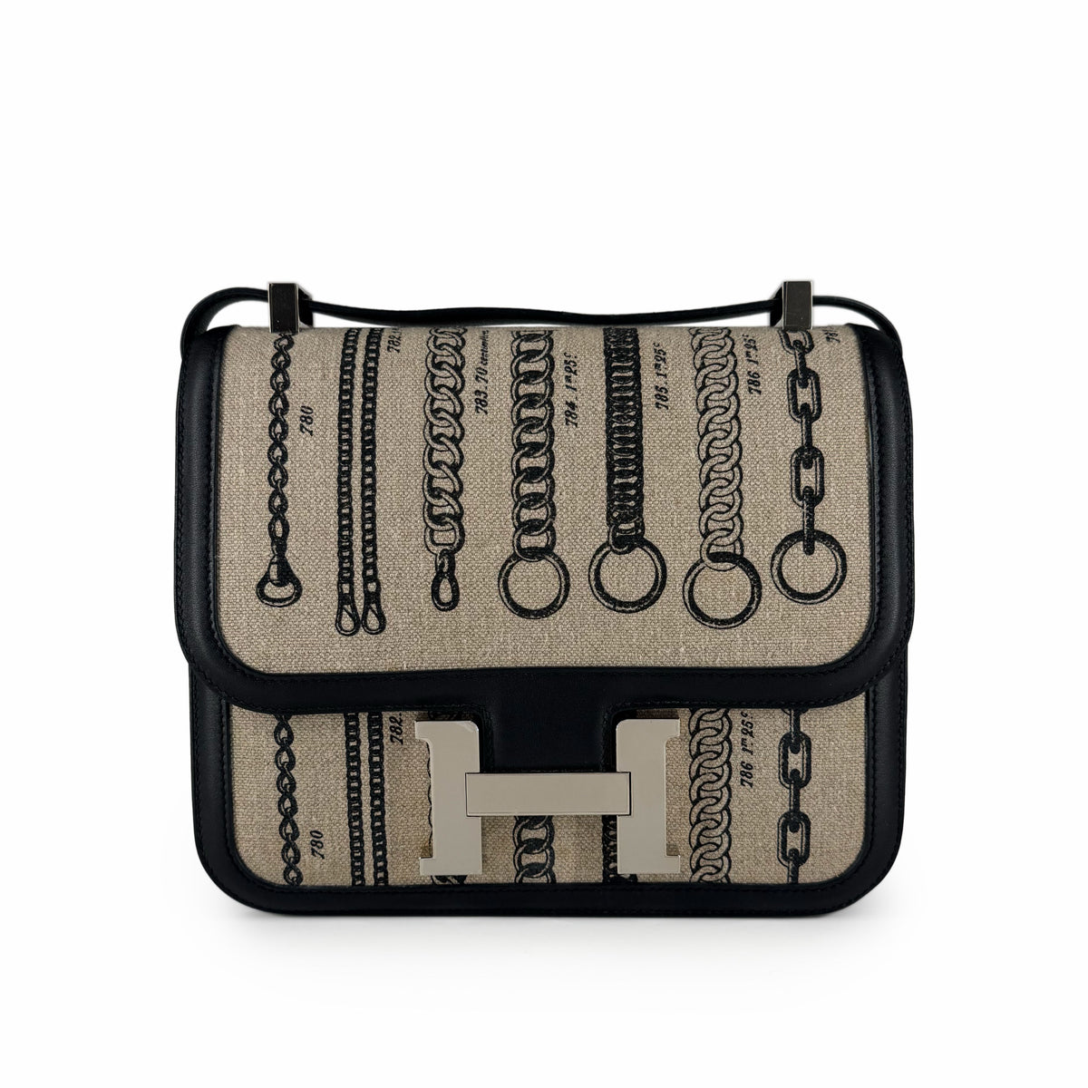 Beige canvas Hermès crossbody bag with black leather trim and silver H hardware, curated Pre-loved Luxury by Myluxe in Helsinki.