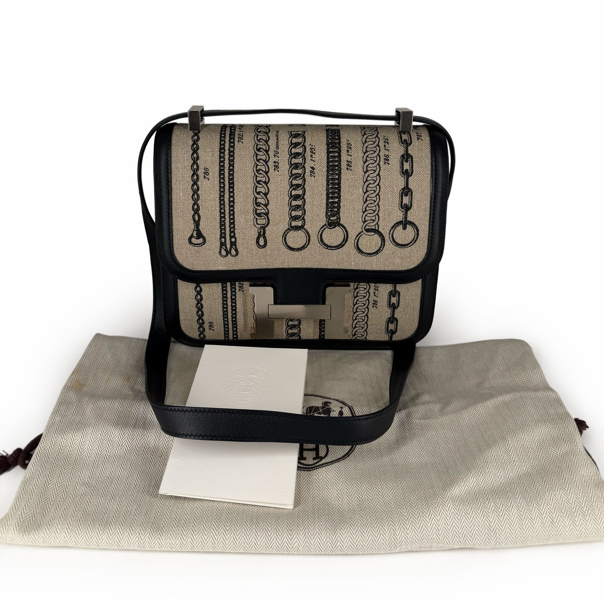 Beige canvas handbag with black chain print and leather trim, curated Pre-loved Luxury by Myluxe in Helsinki.