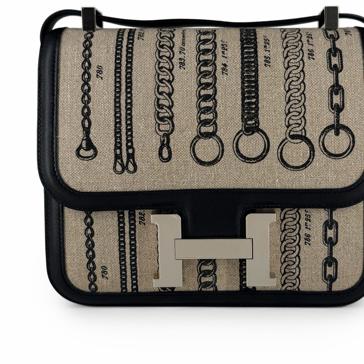 Hermès canvas crossbody bag with black leather trim and silver metal hardware, curated Pre-loved Luxury by Myluxe in Helsinki.