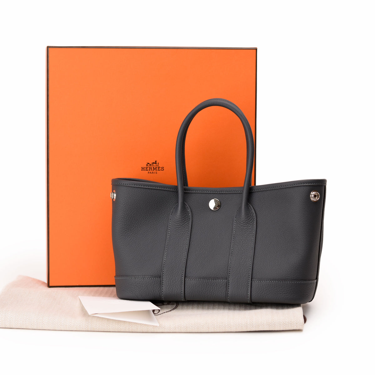 Hermès grey leather tote bag with orange box, curated Pre-loved Luxury by Myluxe in Helsinki.