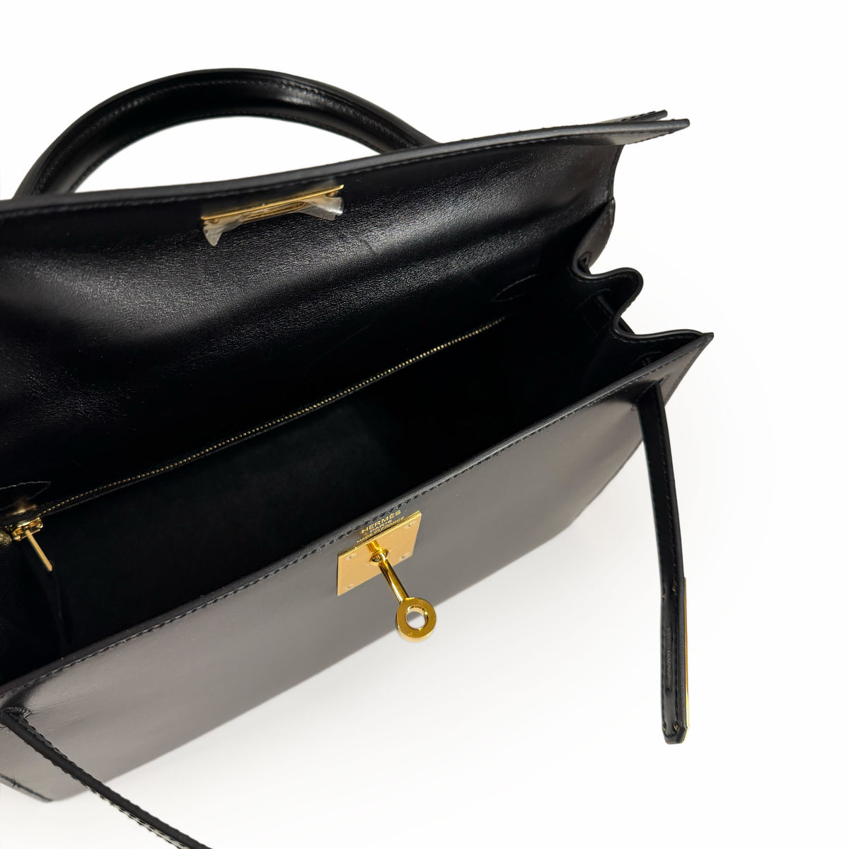 Open black leather luxury handbag with gold-tone hardware, curated Pre-loved Luxury by Myluxe in Helsinki.