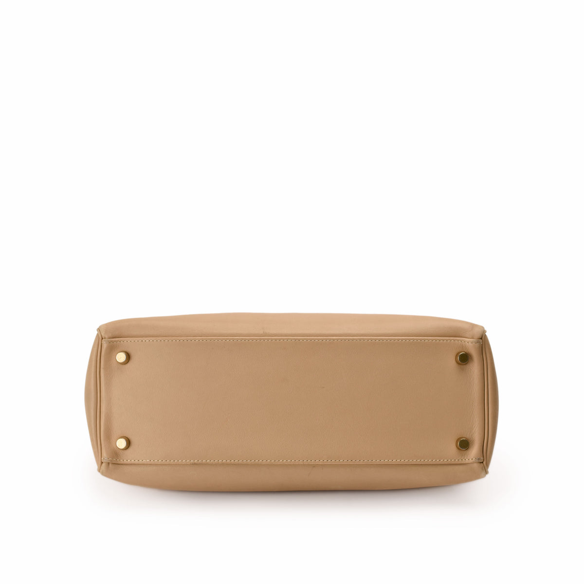 Bottom view of a beige leather luxury handbag with gold-tone feet, curated Pre-loved Luxury by Myluxe in Helsinki.