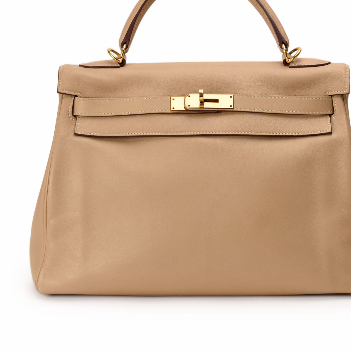 Beige leather Hermès handbag with gold-tone hardware, curated Pre-loved Luxury by Myluxe in Helsinki.