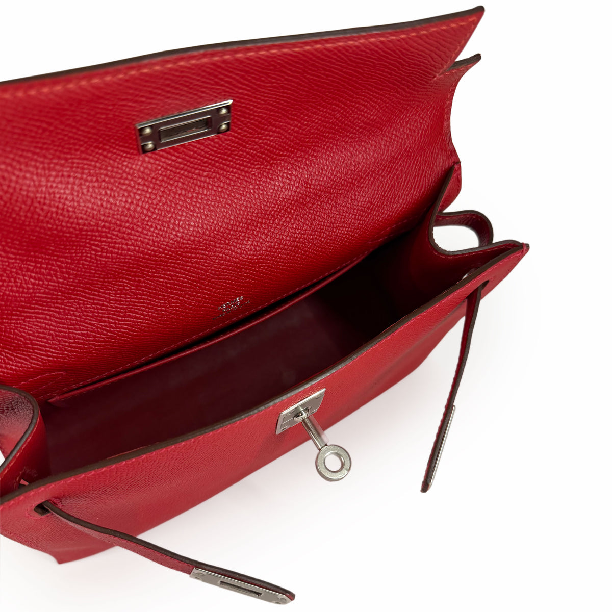Open red pebbled leather luxury handbag with silver hardware, curated Pre-loved Luxury by Myluxe in Helsinki.