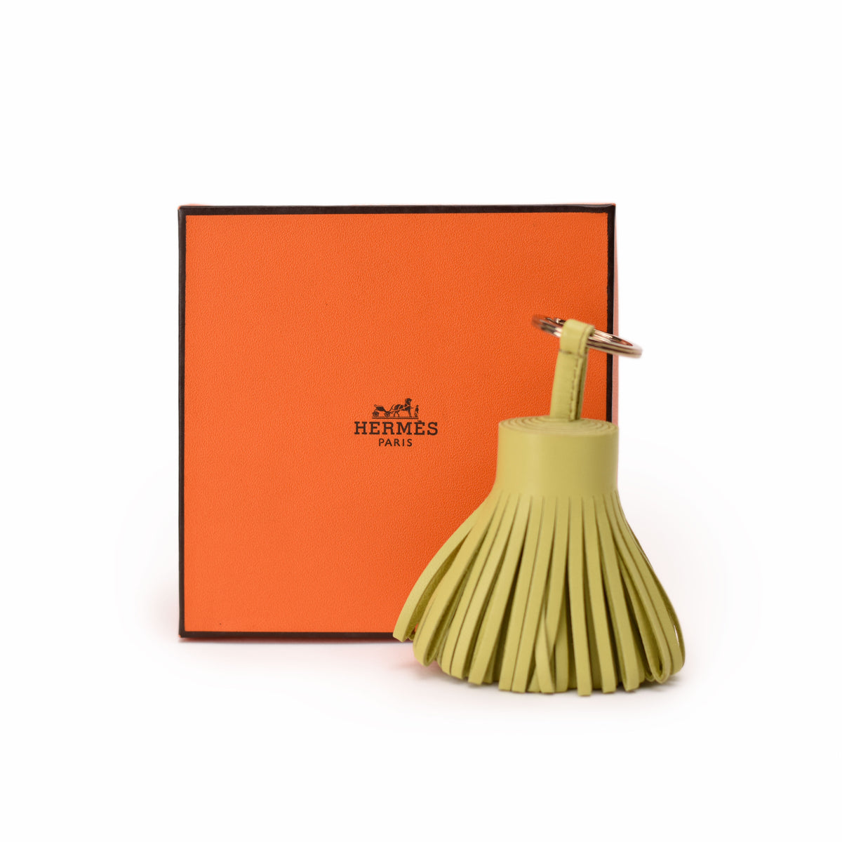 Hermès lime green leather tassel keychain accessory. curated Pre-loved Luxury by Myluxe in Helsinki.