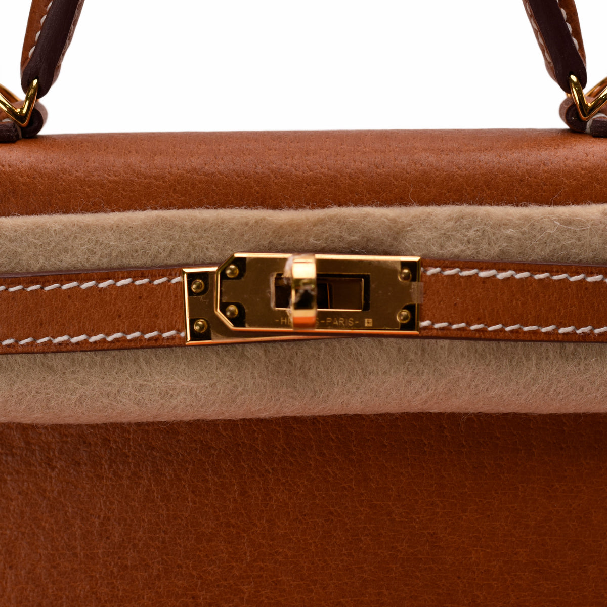 Tan leather handbag with gold-tone metal clasp and cream suede trim, curated Pre-loved Luxury by Myluxe in Helsinki.