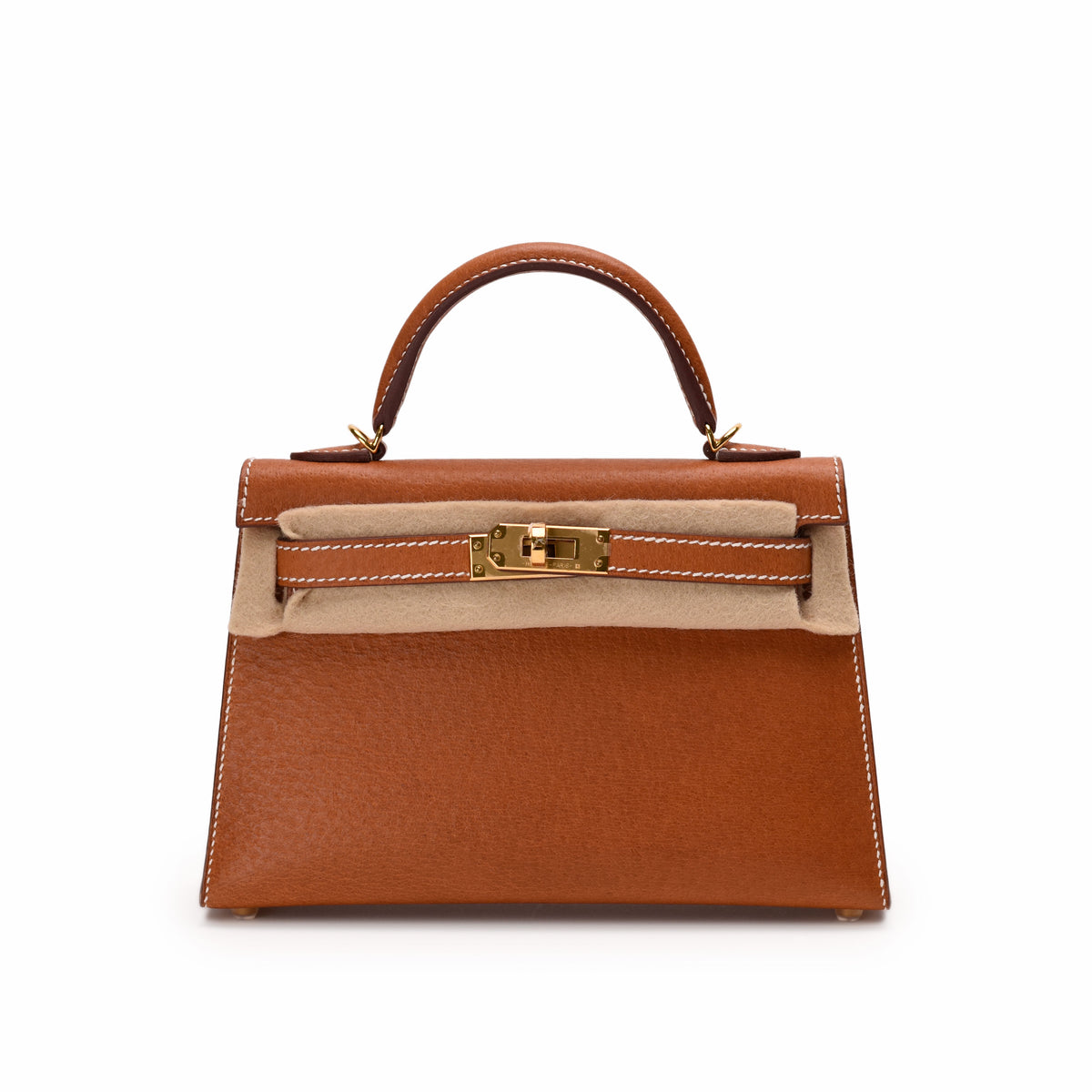 Tan leather Hermès Kelly handbag with gold-tone hardware, curated Pre-loved Luxury by Myluxe in Helsinki.