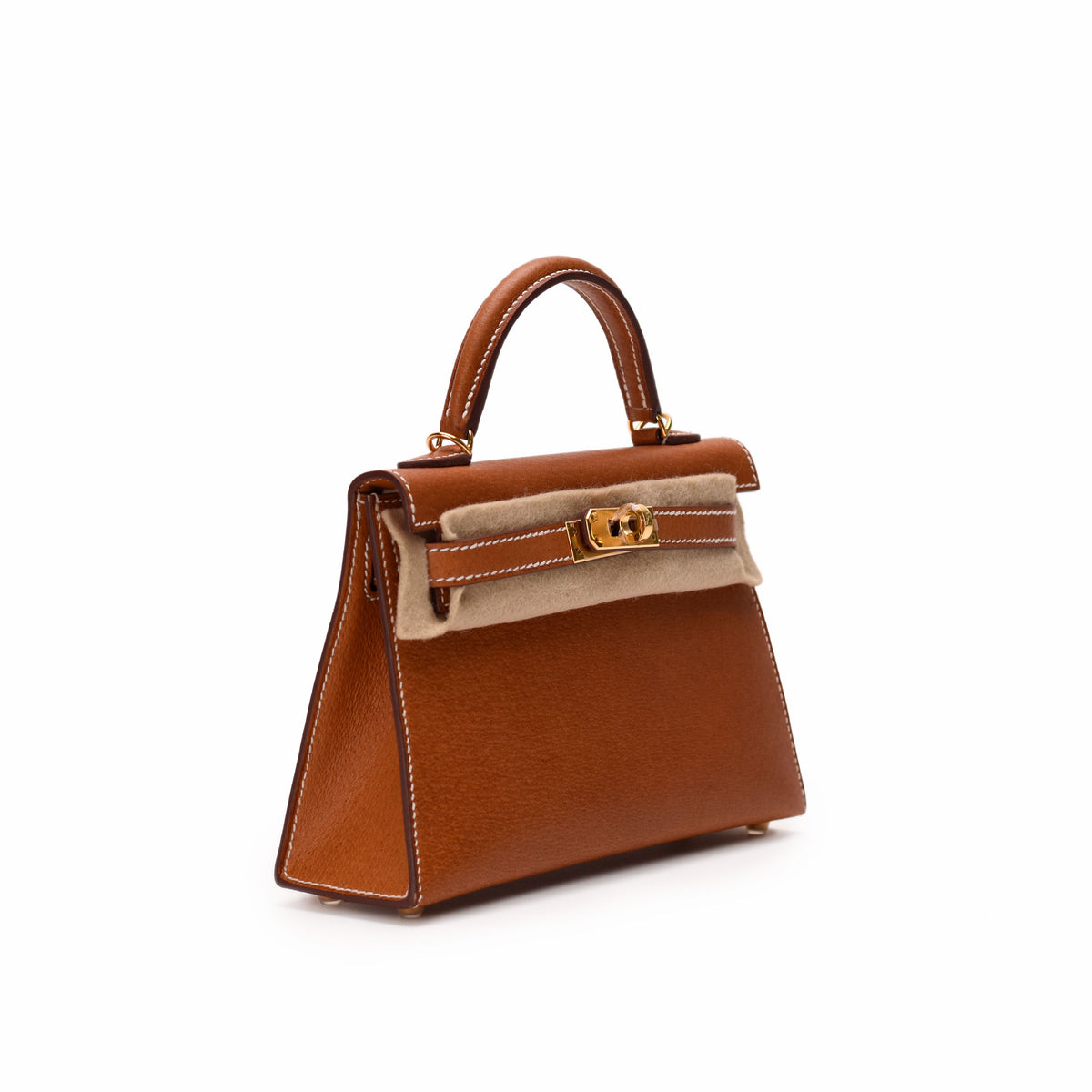 Tan leather top handle handbag with gold hardware, curated Pre-loved Luxury by Myluxe in Helsinki.