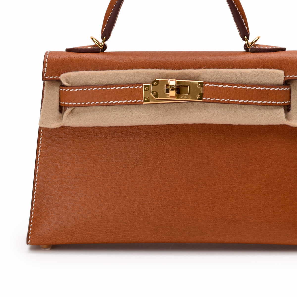 Tan leather luxury handbag with gold-tone hardware, curated Pre-loved Luxury by Myluxe in Helsinki.