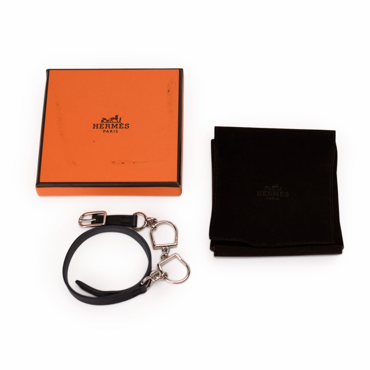 Hermès black leather bracelet with silver-tone hardware and orange box. curated Pre-loved Luxury by Myluxe in Helsinki.