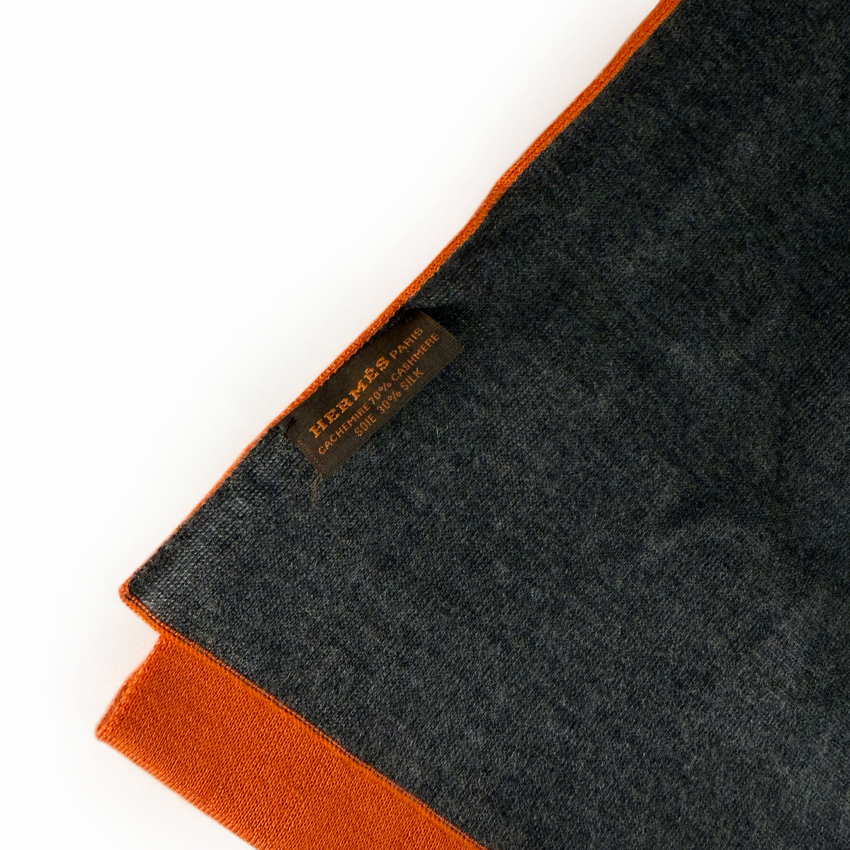 Hermès dark grey cashmere and silk scarf with orange trim, curated Pre-loved Luxury by Myluxe in Helsinki.