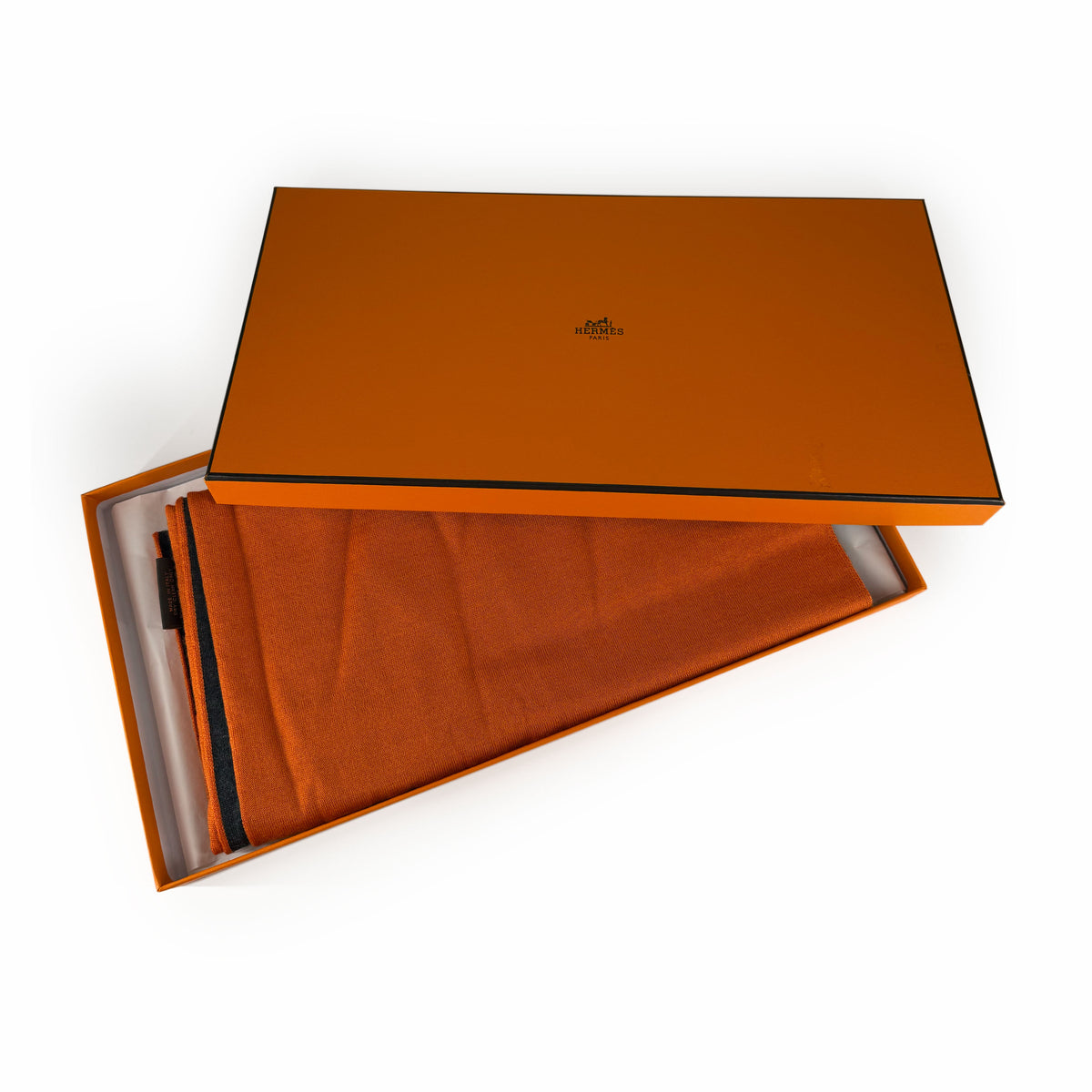 Orange Hermès box and folded orange silk scarf, curated Pre-loved Luxury by Myluxe in Helsinki.