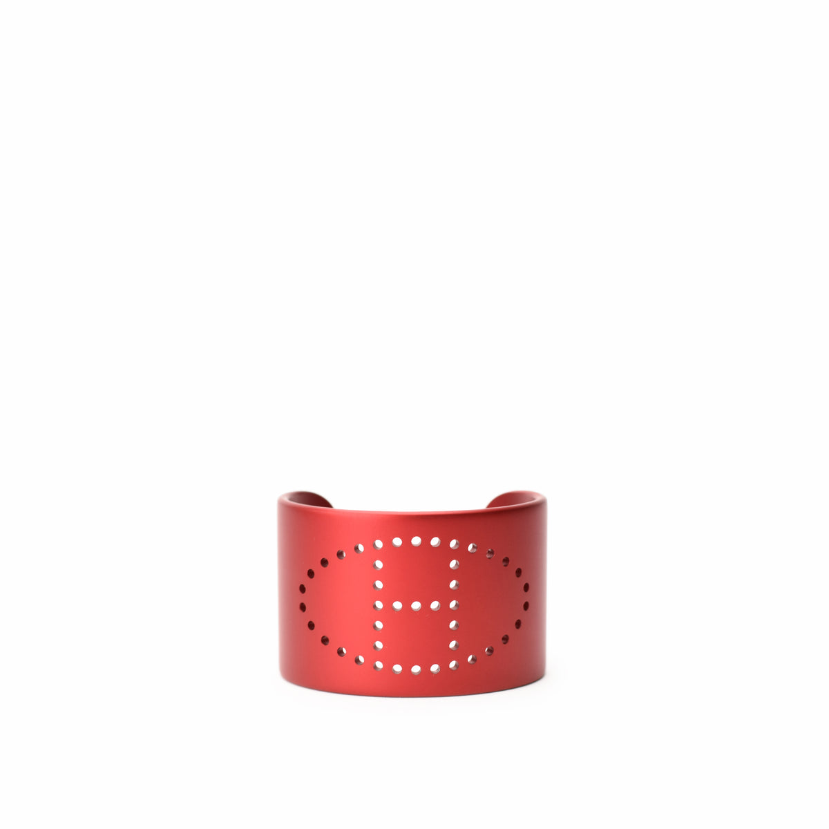 Red metal cuff bracelet with perforated H logo design, curated Pre-loved Luxury by Myluxe in Helsinki.