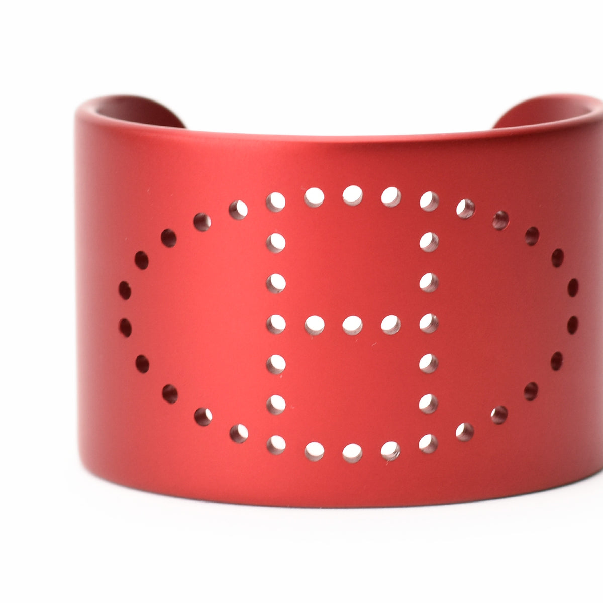 Red matte metal cuff bracelet with perforated H design, curated Pre-loved Luxury by Myluxe in Helsinki.