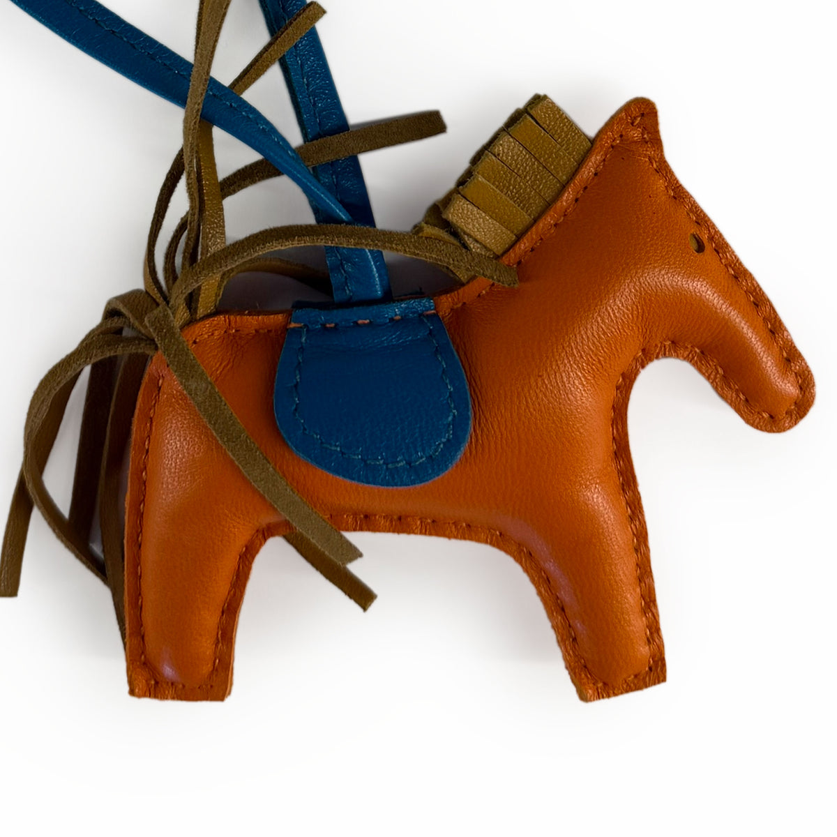 Brown leather horse keychain with blue accents, curated Pre-loved Luxury by Myluxe in Helsinki.