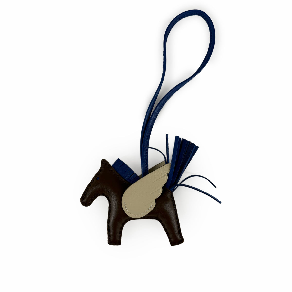 Brown leather winged horse charm with navy blue tassel, curated Pre-loved Luxury by Myluxe in Helsinki.