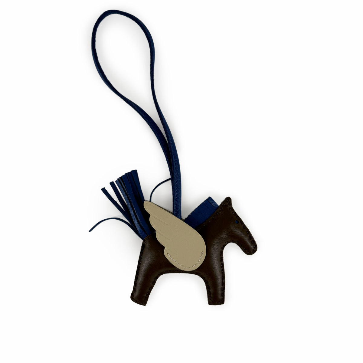 Brown leather winged horse charm with navy blue tassel, curated Pre-loved Luxury by Myluxe in Helsinki.