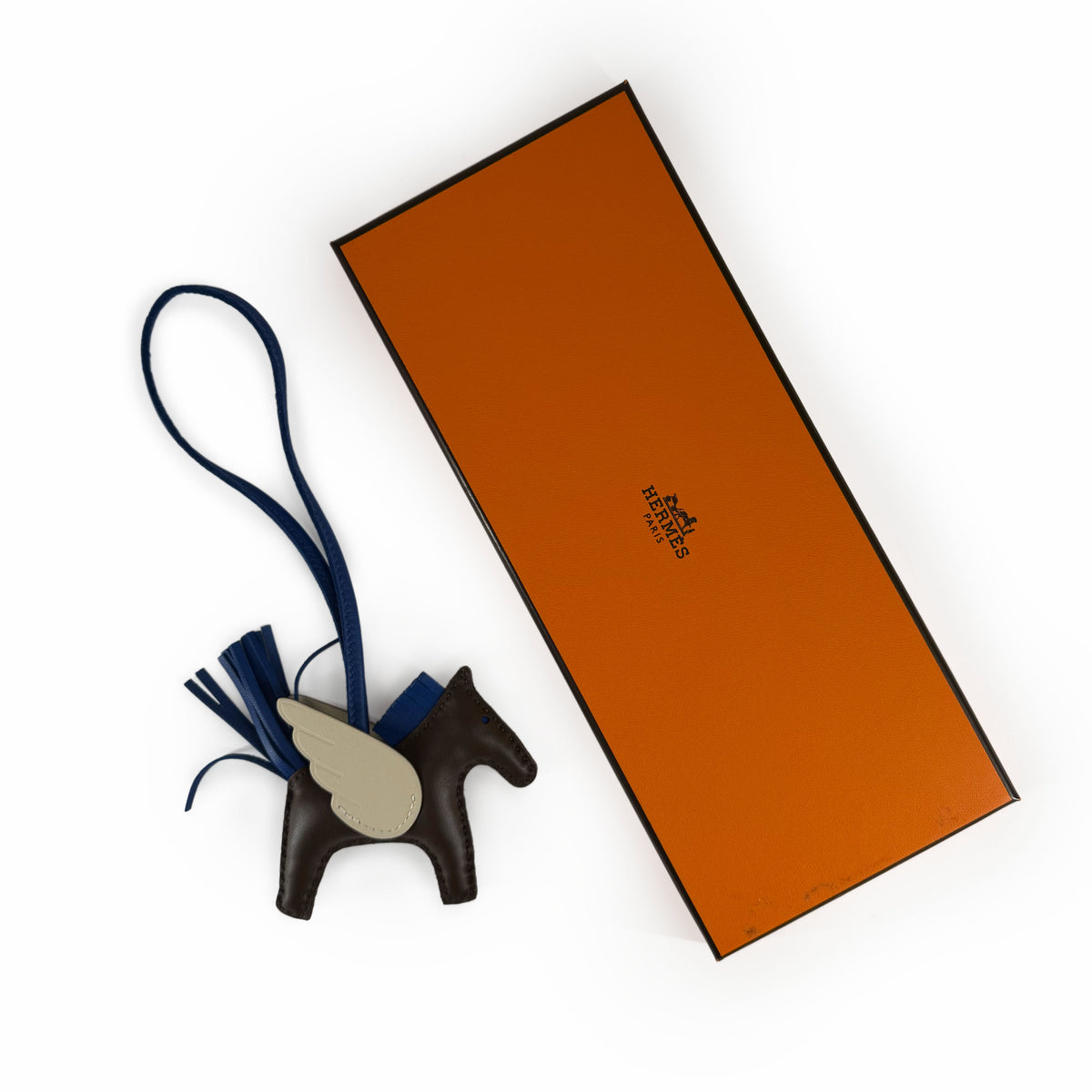 Hermès Pegasus leather bag charm in brown and grey with blue tassel, curated Pre-loved Luxury by Myluxe in Helsinki.