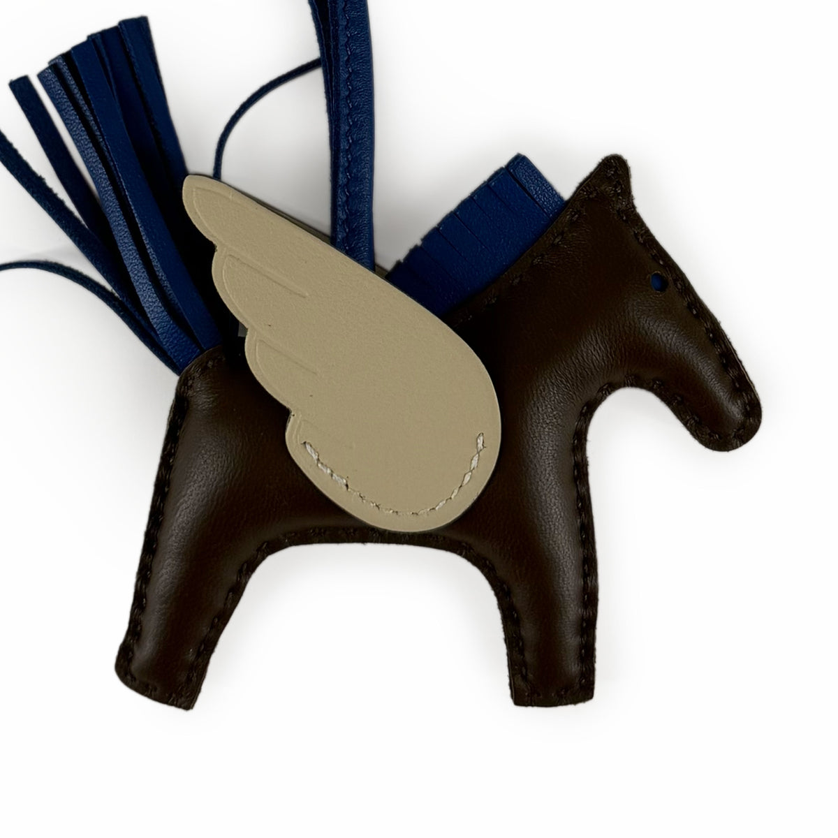 Brown leather horse-shaped charm with tan wing detail and blue tassels, curated Pre-loved Luxury by Myluxe in Helsinki.