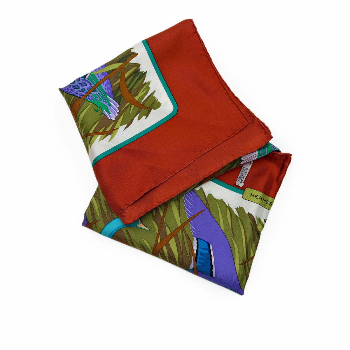 Red silk Hermès scarf with colorful nature motifs, curated Pre-loved Luxury by Myluxe in Helsinki.