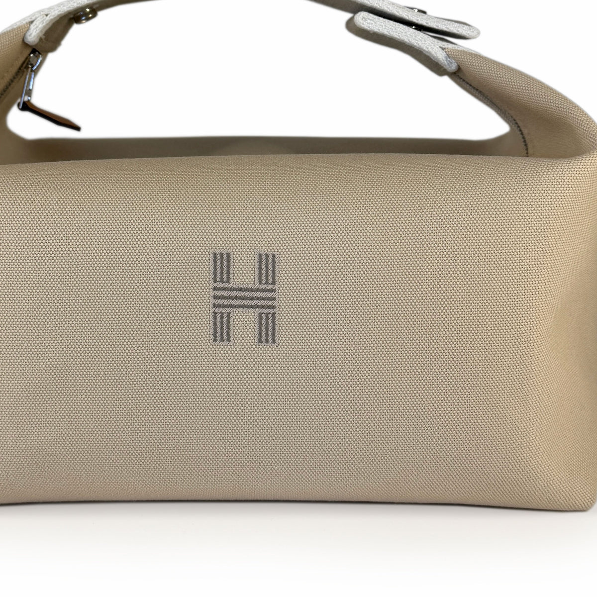 Beige canvas Hermès handbag with silver hardware, curated Pre-loved Luxury by Myluxe in Helsinki.