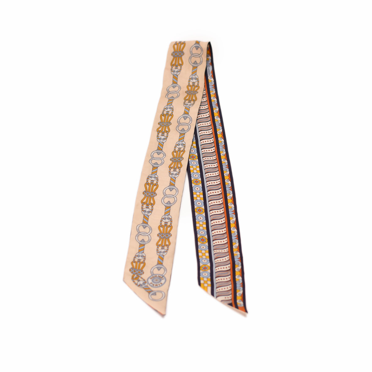 Hermès silk scarf with orange, black, and beige geometric patterns. curated Pre-loved Luxury by Myluxe in Helsinki.