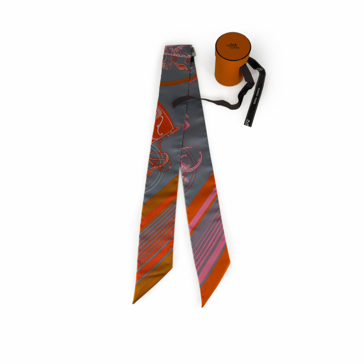 Hermès silk necktie with grey, orange, and pink geometric patterns, curated Pre-loved Luxury by Myluxe in Helsinki.