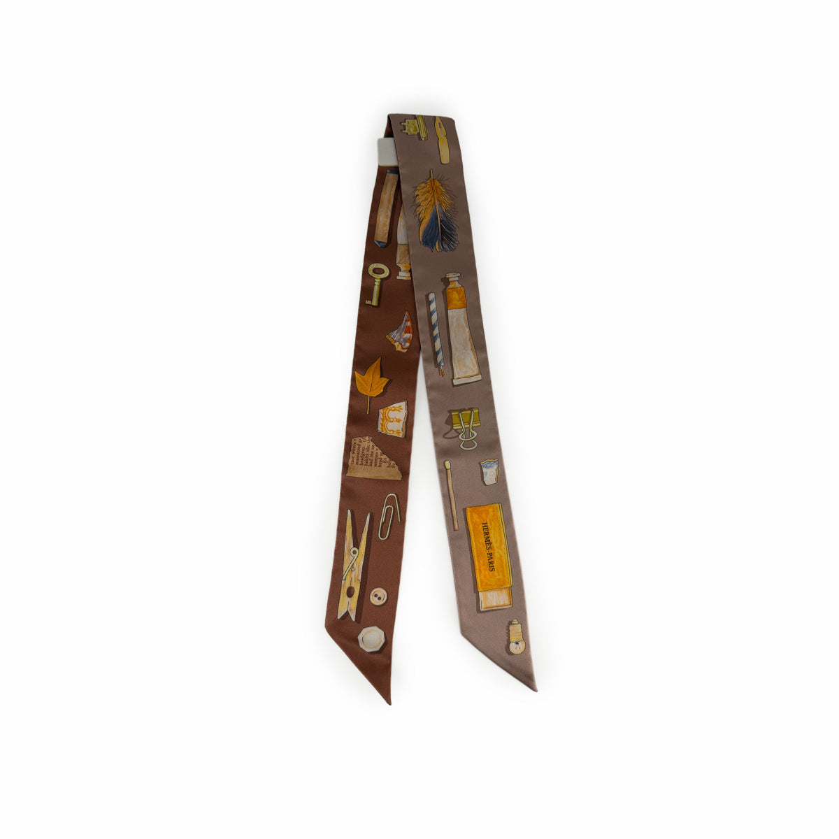Brown silk necktie featuring vintage illustrations of keys, feathers, and stationery, curated Pre-loved Luxury by Myluxe in Helsinki.