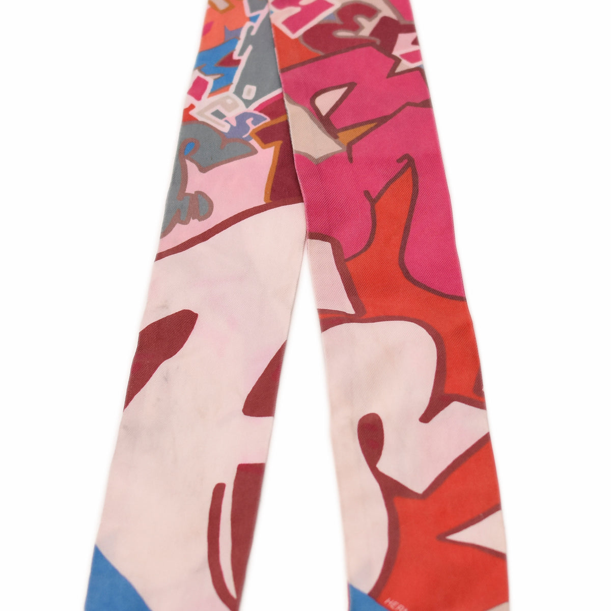 Hermès silk twilly with colorful abstract graffiti print in pink, red, and blue. curated Pre-loved Luxury by Myluxe in Helsinki.