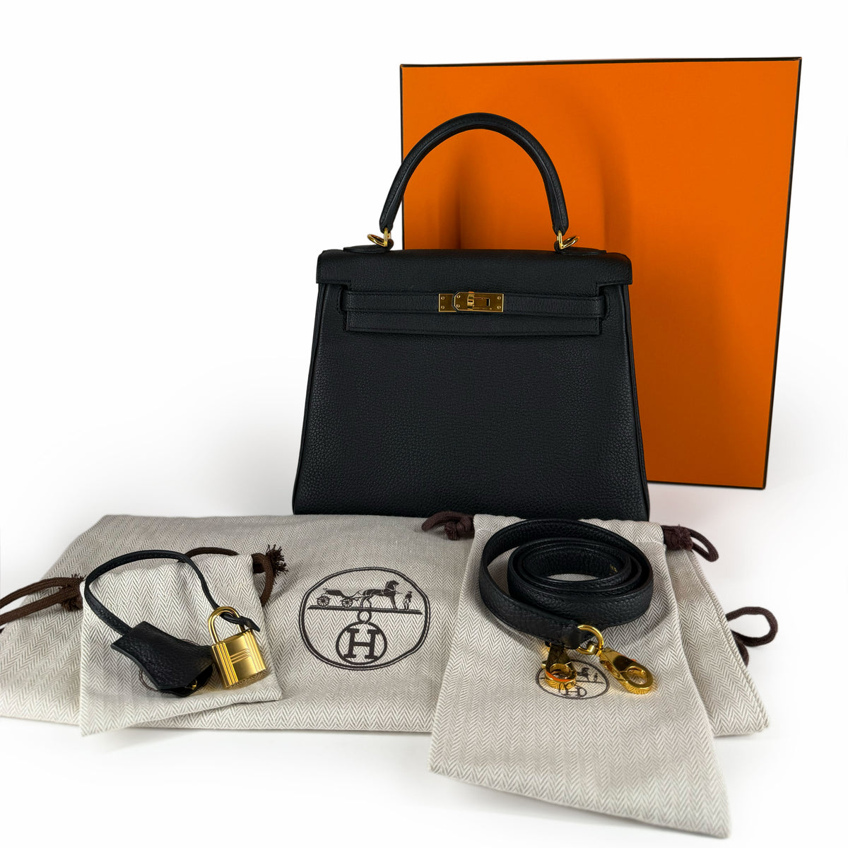 Black Togo leather Hermès Kelly handbag with gold hardware and accessories, curated Pre-loved Luxury by Myluxe in Helsinki.