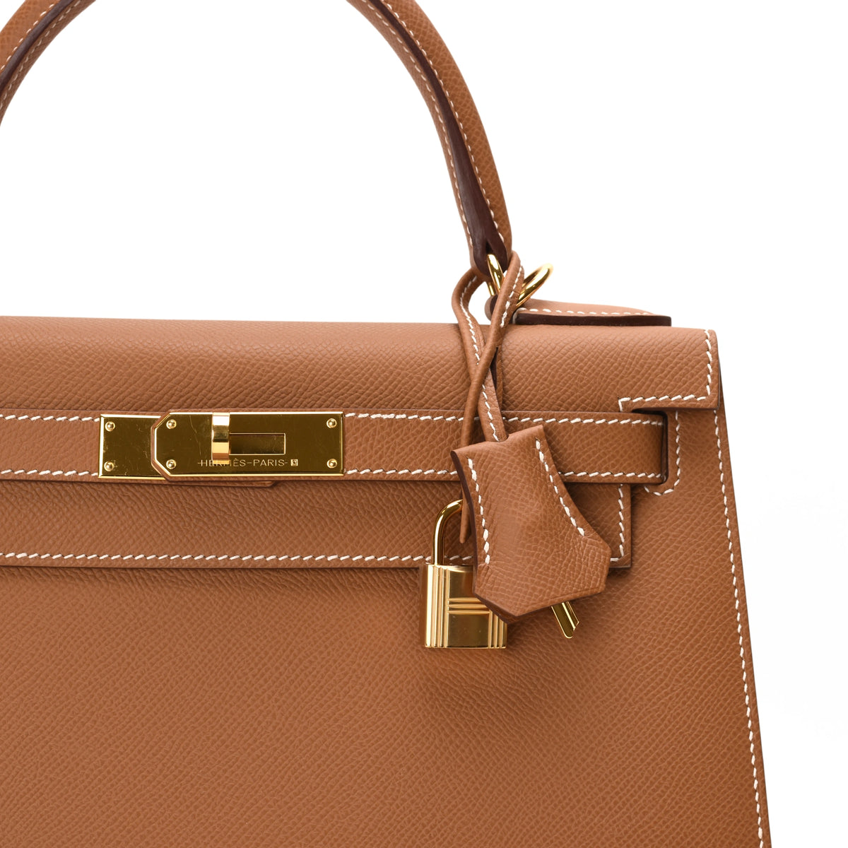 Hermès tan leather handbag with gold hardware and padlock. curated Pre-loved Luxury by Myluxe in Helsinki.