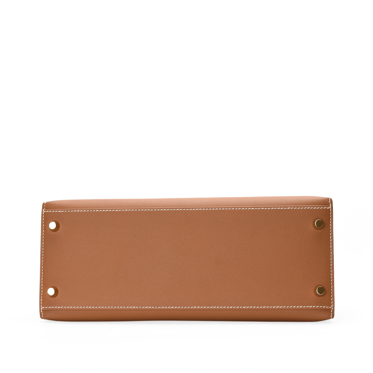 Bottom view of a tan leather Hermès handbag with metal feet, curated Pre-loved Luxury by Myluxe in Helsinki.