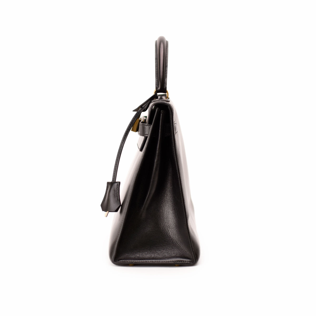 Side view of a black leather Hermès handbag with gold-tone hardware. curated Pre-loved Luxury by Myluxe in Helsinki.
