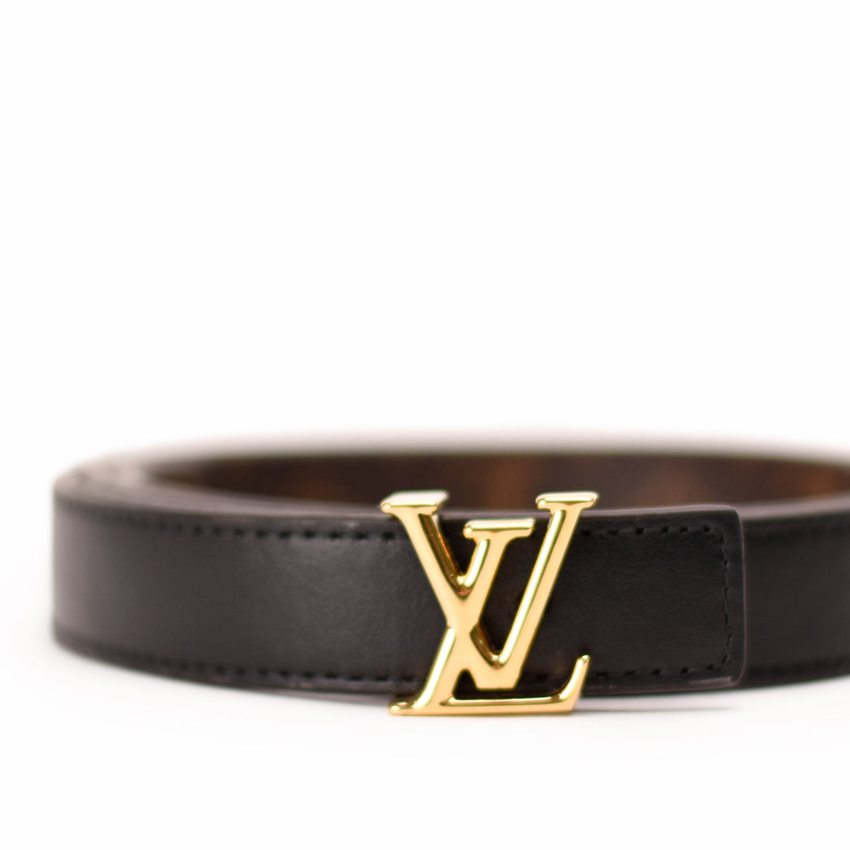Black leather Louis Vuitton belt with gold-tone LV logo, curated Pre-loved Luxury by Myluxe in Helsinki.