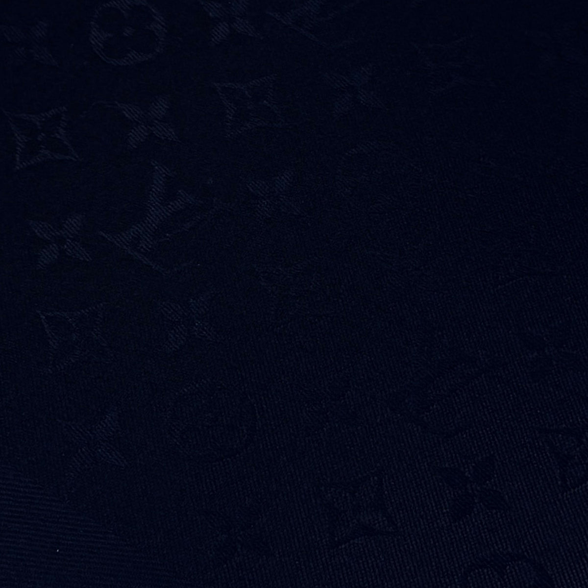 Dark navy monogrammed luxury canvas texture, curated Pre-loved Luxury by Myluxe in Helsinki.