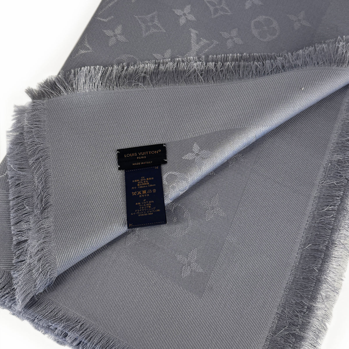 Grey Louis Vuitton monogram silk scarf with fringed edges, curated Pre-loved Luxury by Myluxe in Helsinki.
