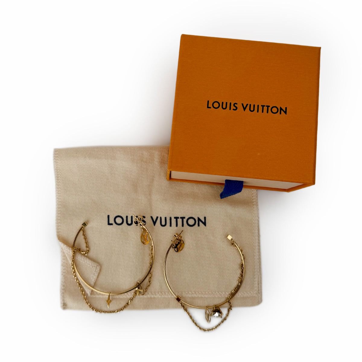 Pair of gold-toned Louis Vuitton hoop earrings with charms, orange box and dust bag. curated Pre-loved Luxury by Myluxe in Helsinki.
