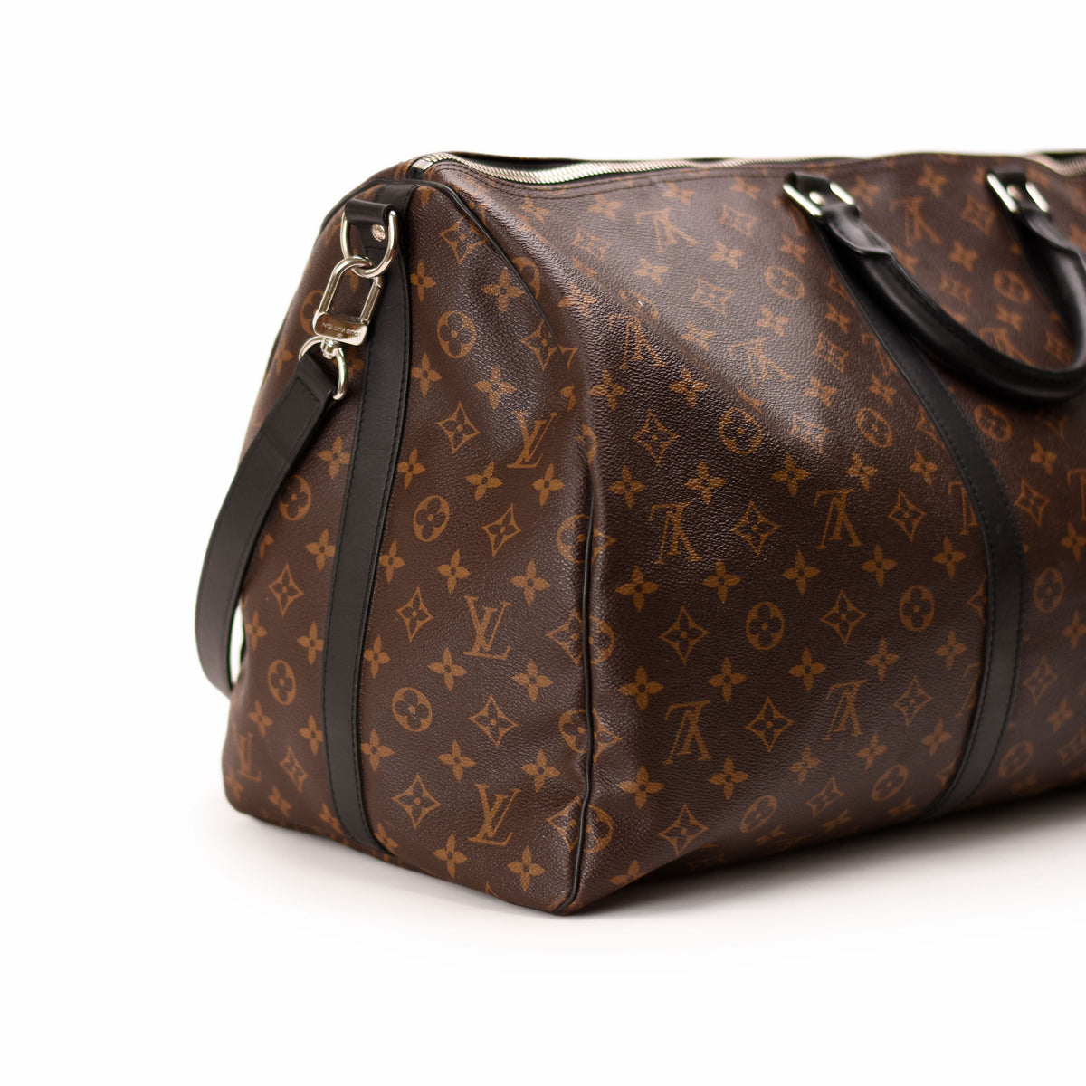 Louis Vuitton Monogram brown canvas duffle bag with black leather trim. curated Pre-loved Luxury by Myluxe in Helsinki.