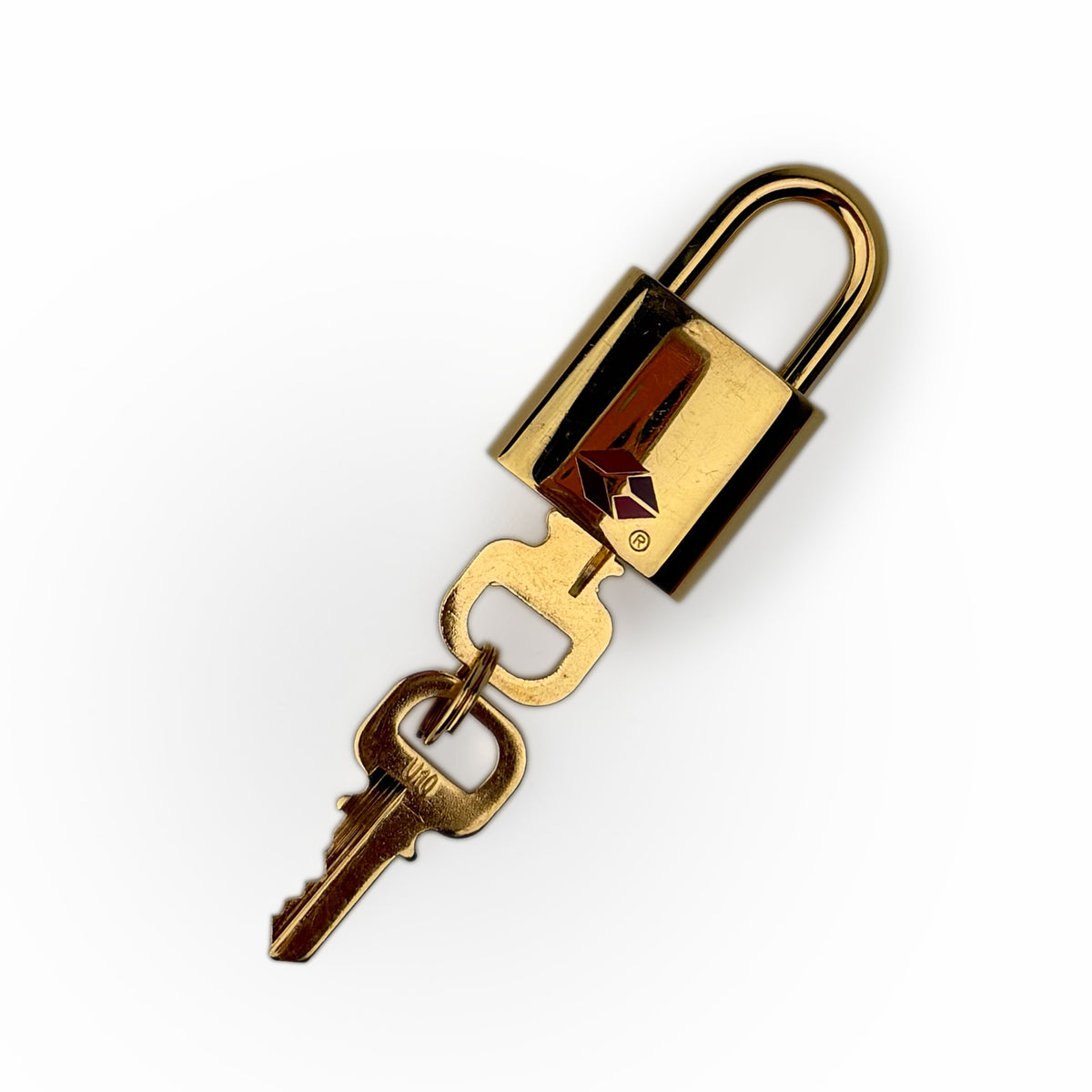Polished gold-tone metal padlock with two matching brass keys, curated Pre-loved Luxury by Myluxe in Helsinki.