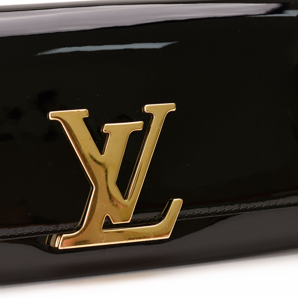 Gold-tone Louis Vuitton logo on black patent leather, curated Pre-loved Luxury by Myluxe in Helsinki.