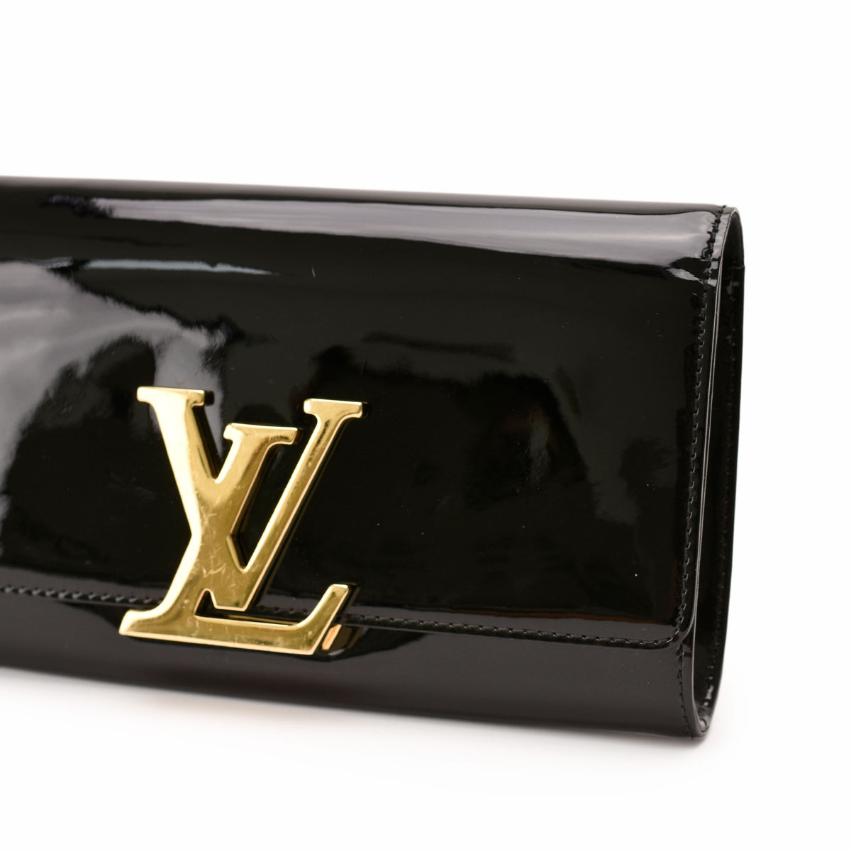 Black patent leather Louis Vuitton clutch with gold-tone LV logo, curated Pre-loved Luxury by Myluxe in Helsinki.