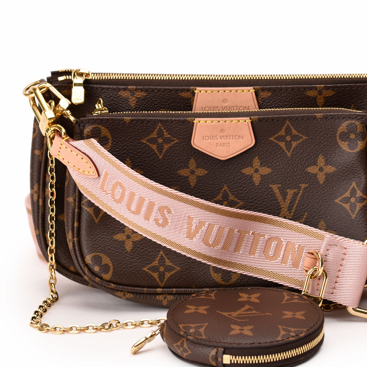 Louis Vuitton Monogram canvas crossbody bag with pink logo strap. curated Pre-loved Luxury by Myluxe in Helsinki.