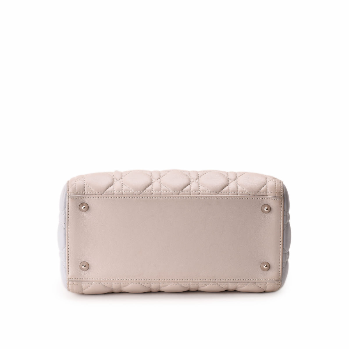 Bottom view of a quilted pale pink leather handbag with metal studs, curated Pre-loved Luxury by Myluxe in Helsinki.